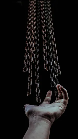 Chains being released from someone's hand